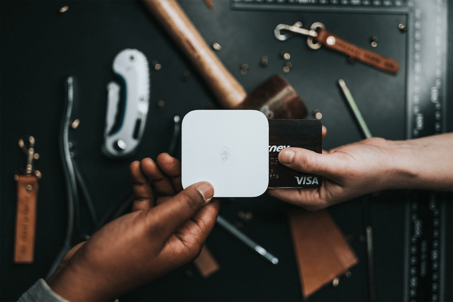 Cardholder concealing credit card numbers while paying.