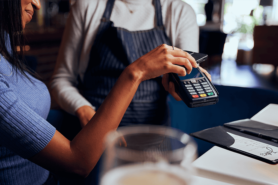 Making credit card payment at table while dining out.