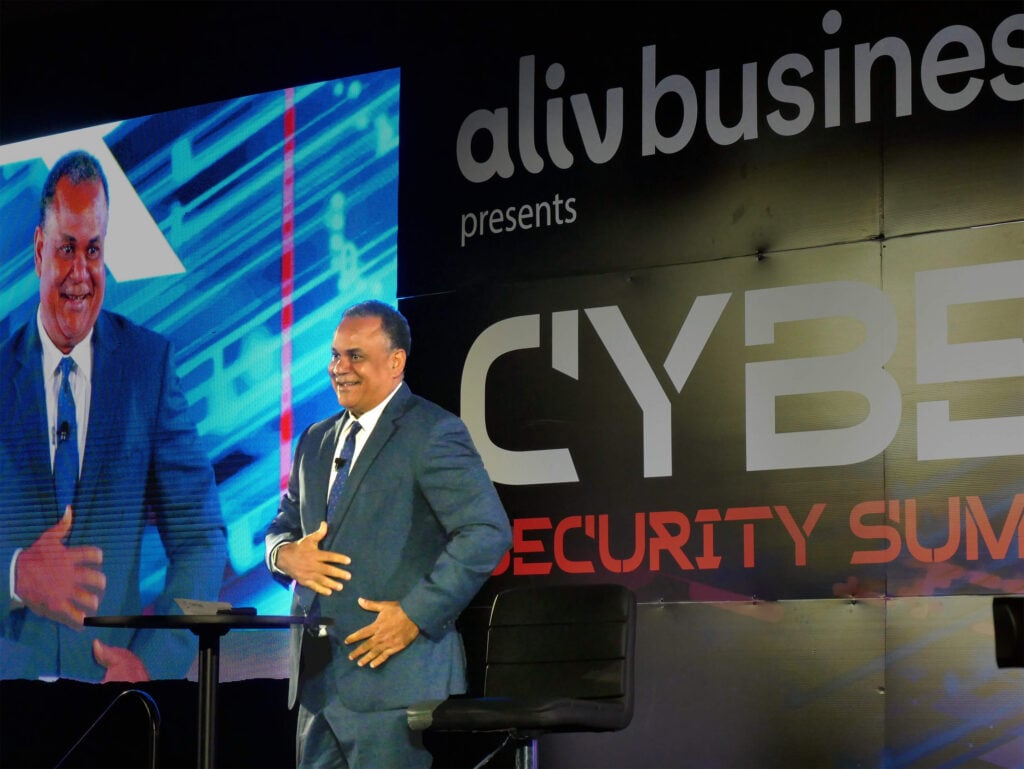 Minister of Economic Affairs, Senator the Hon. Michael Halkitis delivering welcome remarks at the ALIV Business Cyber Security Summit 2025